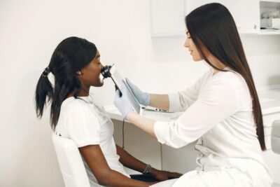A specialist performing a skin analysis on a patient using advanced equipment in a clinic.